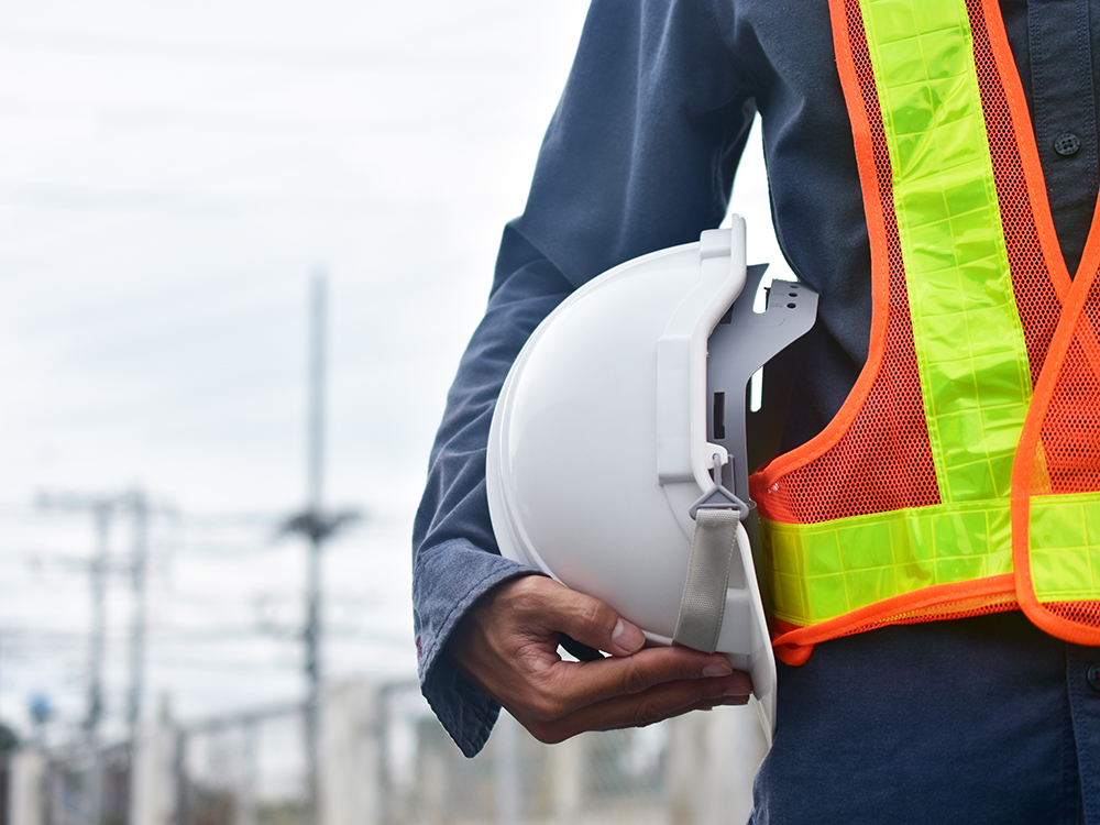 Close up hand holding white hard hat safety Engineer Technician